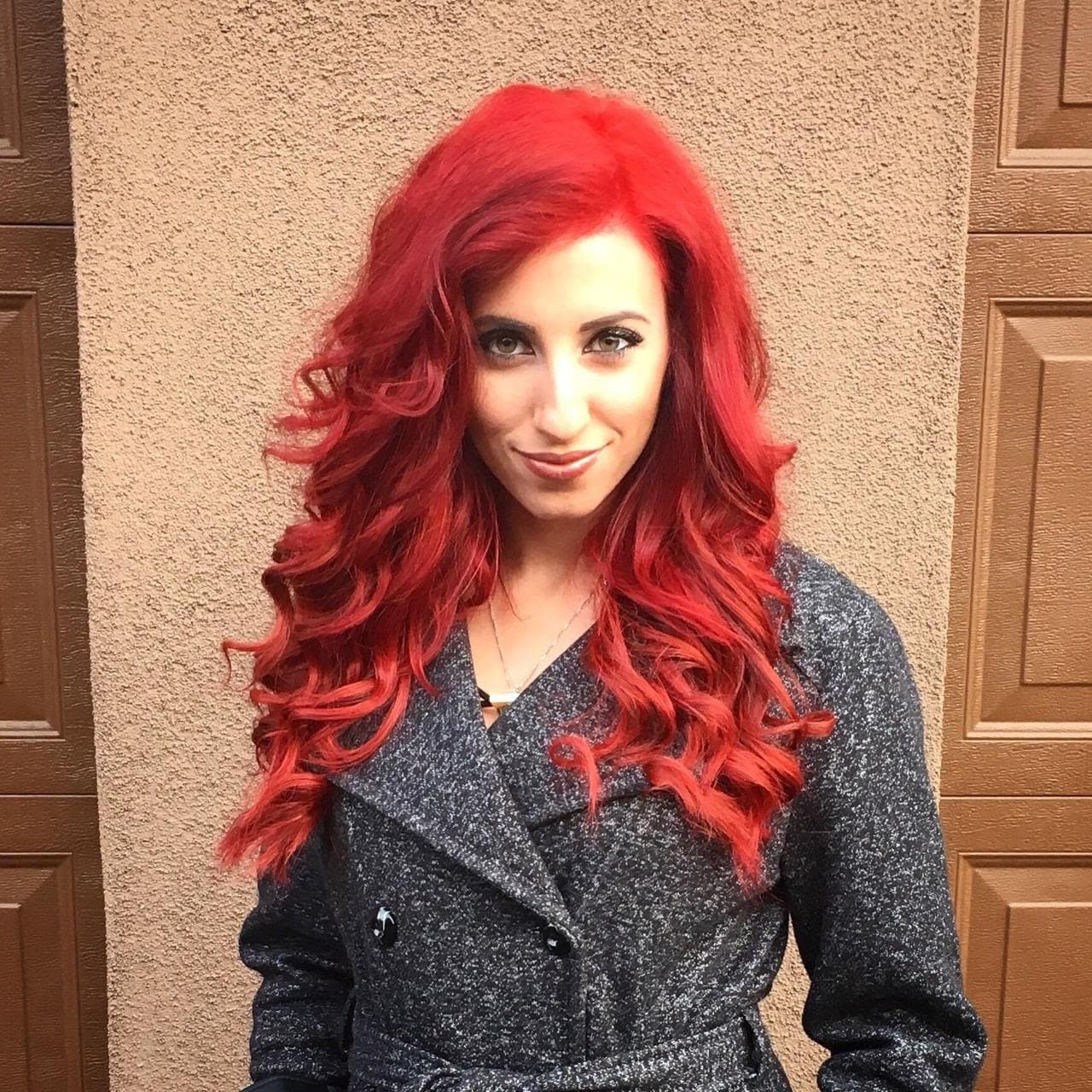 Client with long red hair styled in layered, defined curls